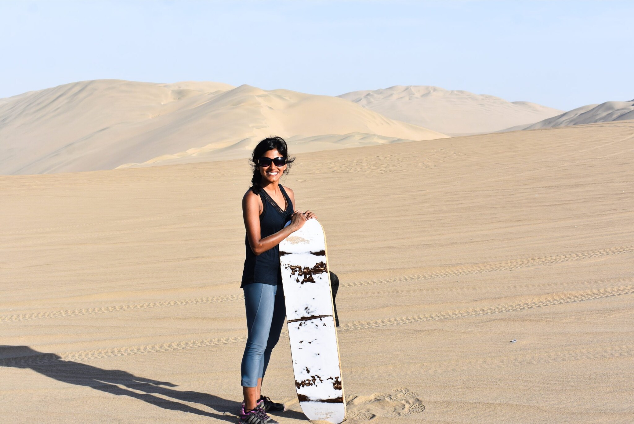 Sandboarding in Peru offers an exhilarating ride down the towering dunes of Huacachina, surrounded by stunning desert landscapes